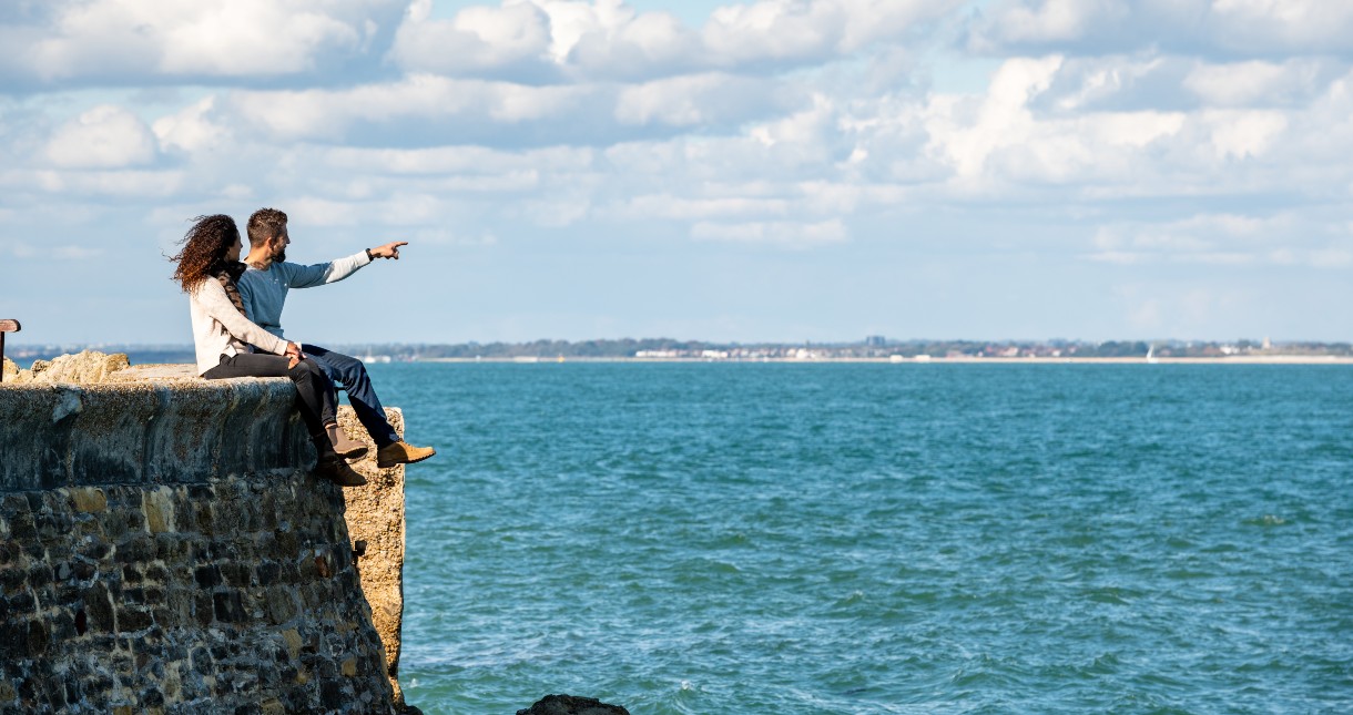 Couple pointing out to sea, Isle of Wight